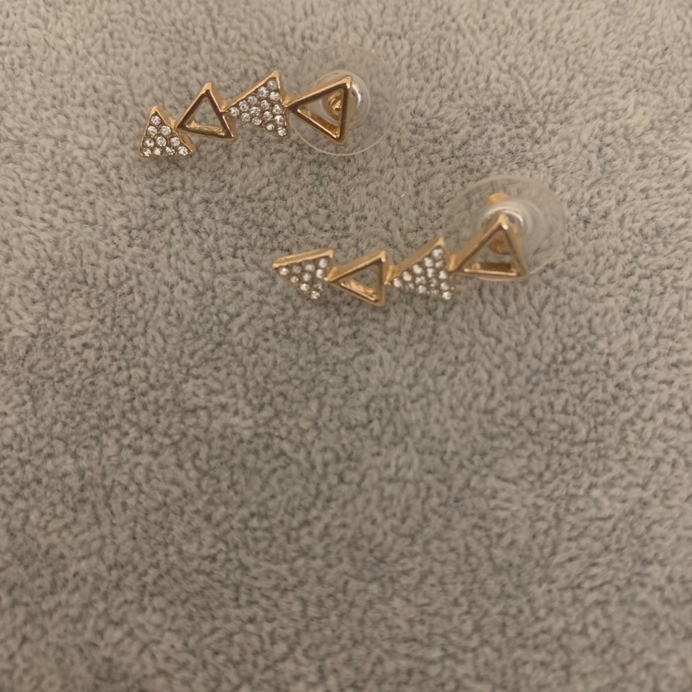 Gold triangle earrings goes up the ear